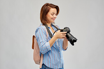 Image showing happy tourist woman with backpack and camera