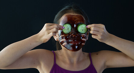 Image showing young asian girl having fun with a chocolate mask