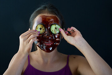 Image showing young asian girl having fun with a chocolate mask