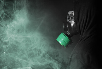 Image showing Man in a gas mask in the smoke