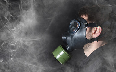 Image showing Man in a gas mask in the smoke