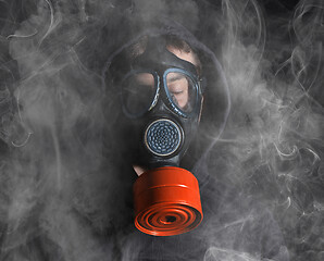 Image showing Man in a gas mask in the smoke