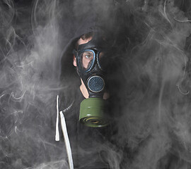 Image showing Man in a gas mask in the smoke