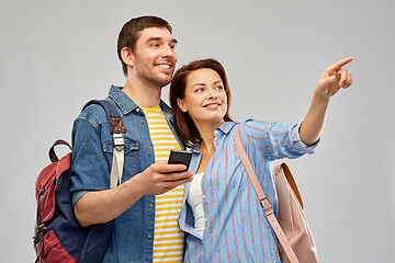 Image showing happy couple of tourists with smartphone
