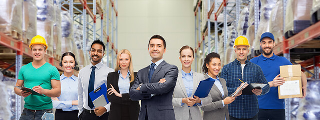 Image showing group of business people and warehouse workers