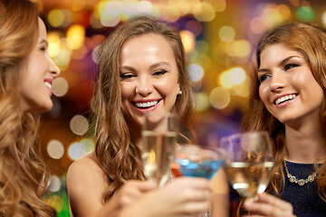 Image showing happy women clinking glasses at night club