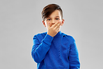 Image showing shocked boy closing mouth by hand