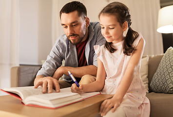 Image showing father and daughter doing homework together
