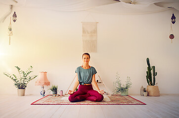 Image showing woman meditating in lotus pose at yoga studio