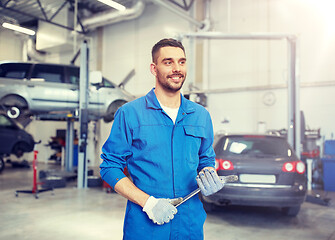 Image showing auto mechanic or smith with wrench at car workshop