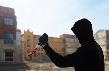 Image showing close up of criminal with blood on knife