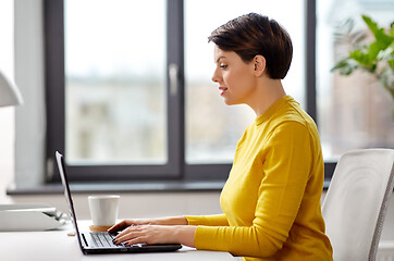 Image showing businesswoman with laptop working at office