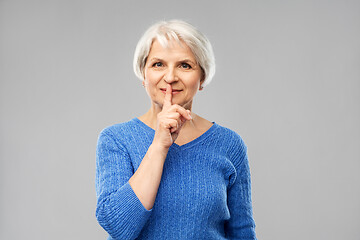 Image showing senior woman making shush gesture