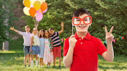 Image showing boy with glasses showing peace at birthday party