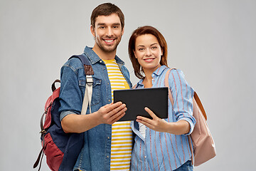 Image showing happy couple of tourists with tablet computer