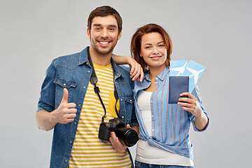 Image showing happy couple with air tickets, passport and camera