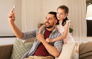 Image showing father and daughter taking selfie at home