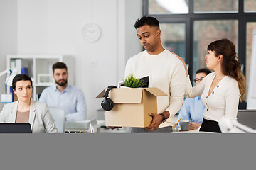 Image showing colleague seeing off sad fired male office worker