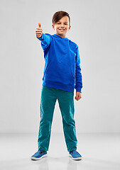 Image showing smiling boy in blue hoodie showing thumbs up