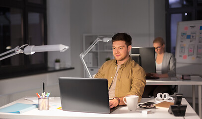 Image showing man with computer working late at night office