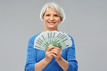 Image showing senior woman with hundreds of euro money banknotes