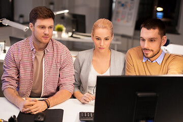 Image showing business team with computer working late at office