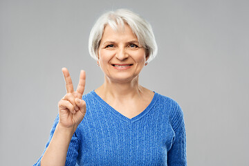 Image showing portrait of smiling senior woman showing peace