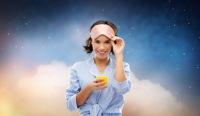 Image showing woman in pajama and sleeping mask with juice