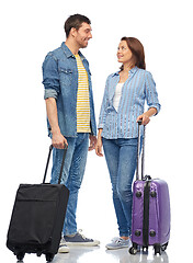 Image showing happy couple of tourists with travel bags talking