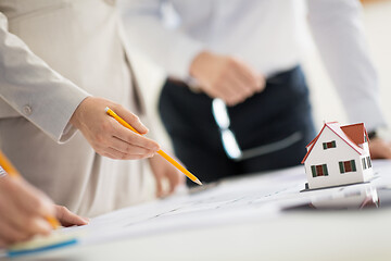 Image showing close up of architects with blueprint at office