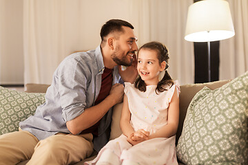 Image showing happy father whispering secret to daughter at home