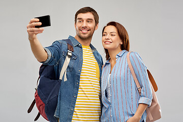 Image showing couple of tourists taking selfie by smartphone