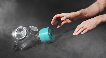 Image showing Man in room filled with smoke, trying to reach for vintage gasma