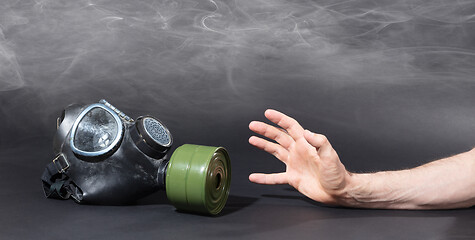 Image showing Man in room filled with smoke, trying to reach for vintage gasma