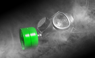 Image showing Vintage gasmask isolated on black - Smoke in the room - Green fi