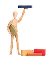 Image showing Wooden mannequin carrying a wooden block
