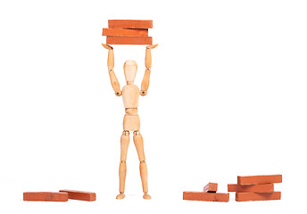 Image showing Wooden mannequin carrying wooden blocks