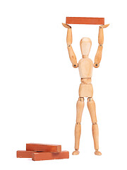 Image showing Wooden mannequin carrying a wooden block