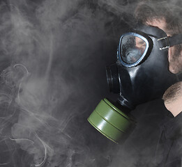 Image showing Man in a gas mask in the smoke