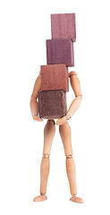 Image showing Wooden mannequin carrying wooden hardwood blocks