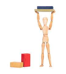 Image showing Wooden mannequin carrying wooden blocks