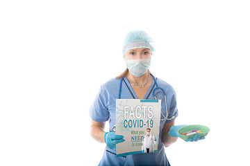 Image showing COVID-19 - Nurse hospital pathologist holds a brochure and blood