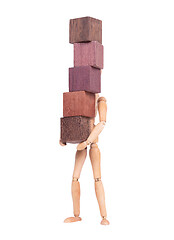 Image showing Wooden mannequin carrying wooden hardwood blocks