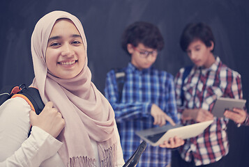 Image showing Arab teenagers group working on laptop and tablet computer