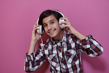 Image showing Arab Teenage Boy Wearing Headphones And Listening To Music