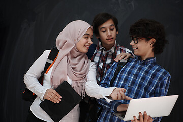 Image showing Arab teenagers group working on laptop and tablet computer