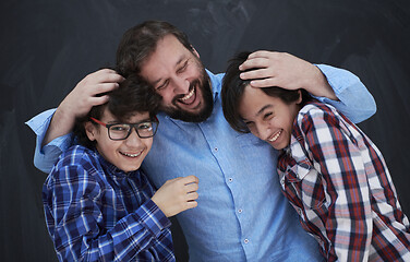 Image showing happy father hugging sons