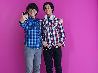Image showing Arab teenagers  against pink wall
