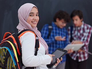 Image showing Arab teenagers group working on laptop and tablet computer