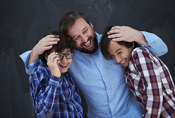 Image showing happy father hugging sons